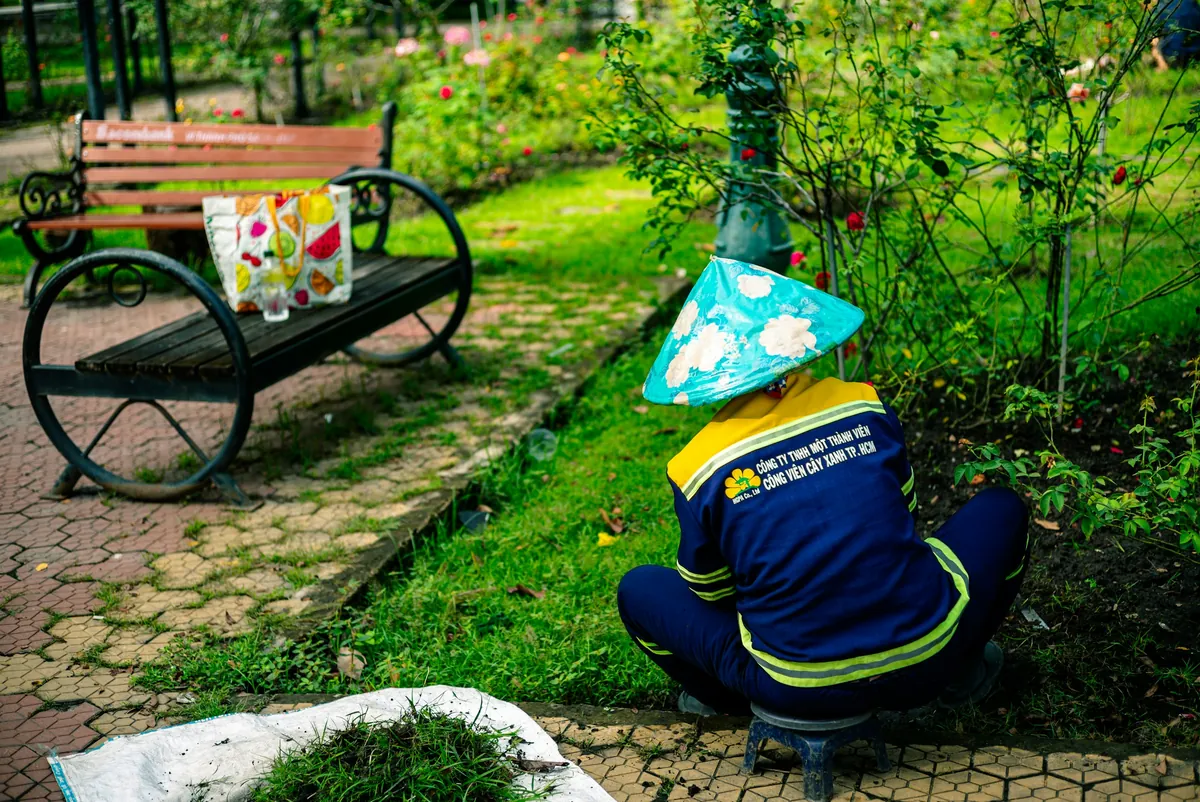 Gardener tending plants in a landscaped park